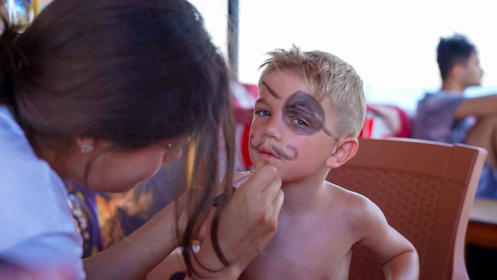 A person applying makeup to another individual. 2