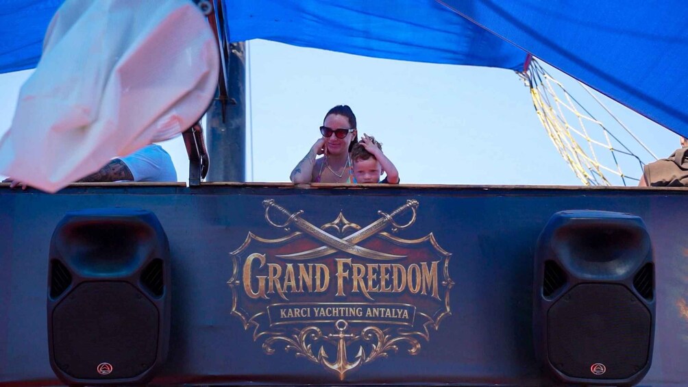 A yacht named 'Grand Freedom' with a logo featuring crossed swords and an anchor. 5