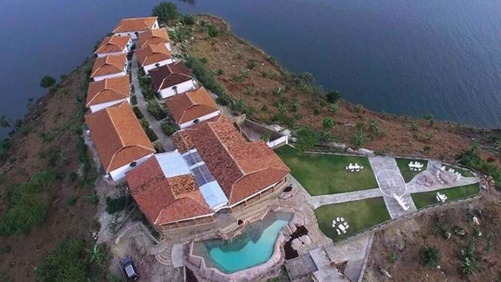 A coastal resort with terraced houses, a swimming pool, and a landscaped garden. 3