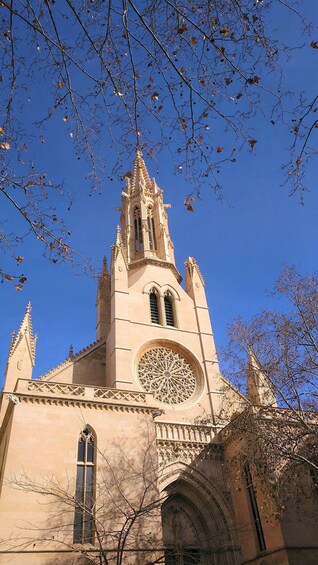 A church with a tall spire and intricate window designs. 3
