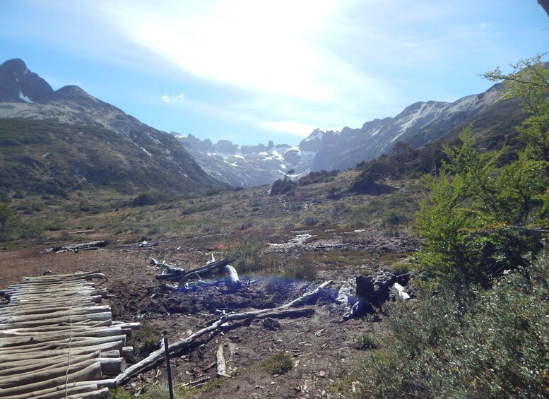 A mountainous landscape with a wooden walkway leading through a rocky area. 5
