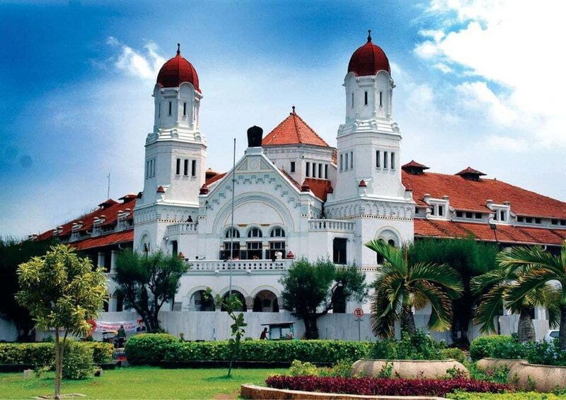 A white building with two red domes and a red-tiled roof. 1