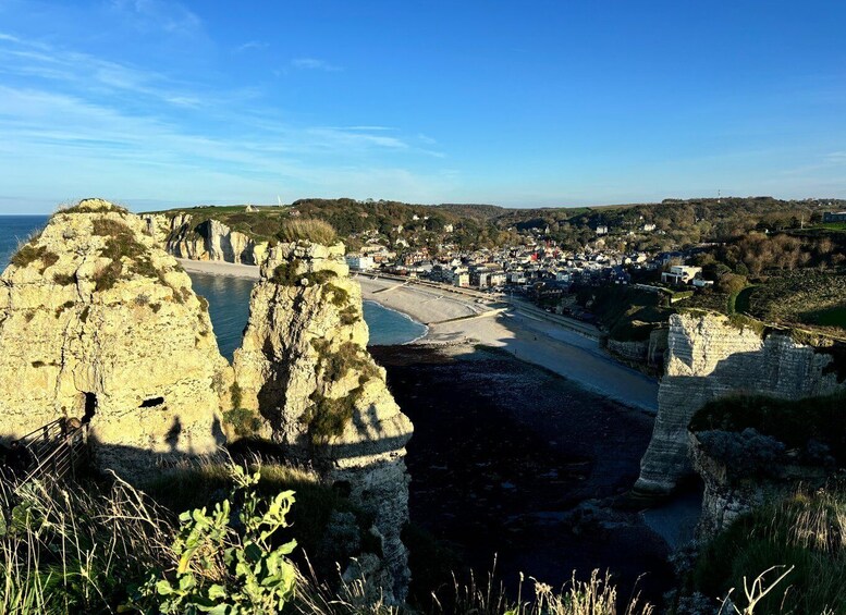 A coastal town with cliffs, a beach, and a winding road. 5