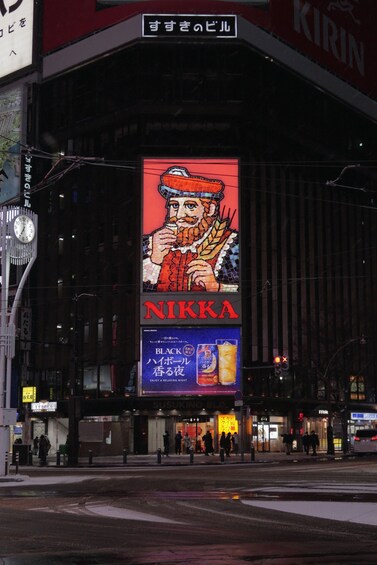A building with a large billboard featuring a cartoon character and the word 'NIKKA'. 4