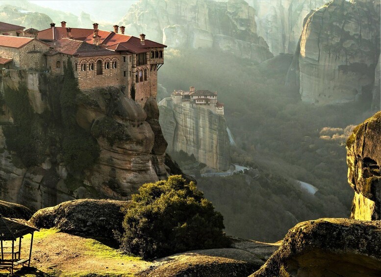 A monastery perched on a cliffside with a steep drop below. 3