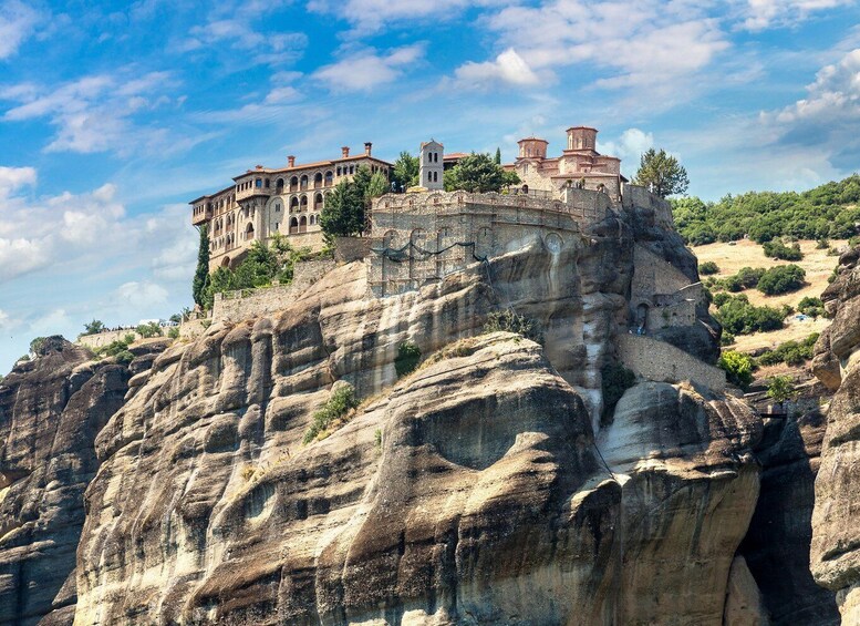 A historic building perched atop a rocky cliff. 2