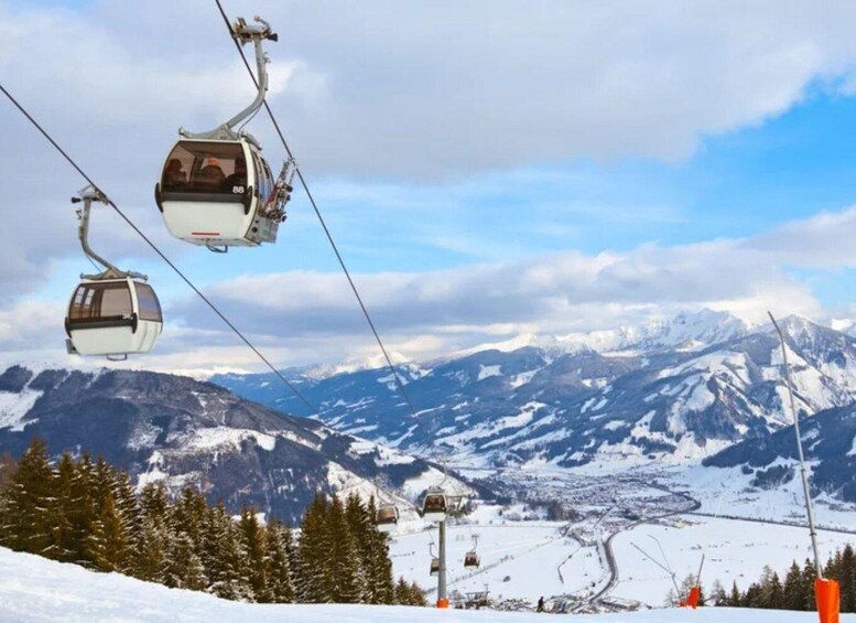 A cable car system in a snowy mountainous area with clear skies. 2