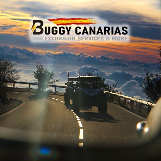A vehicle on a road with a sunset in the background and a logo for Buggy Canarias. 1