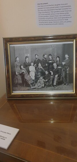 A framed historical photograph of a family with a caption about the Freud family. 4