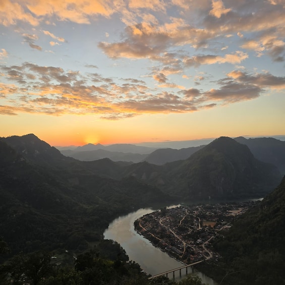 A river valley with a town, mountains, and a sunset. 4