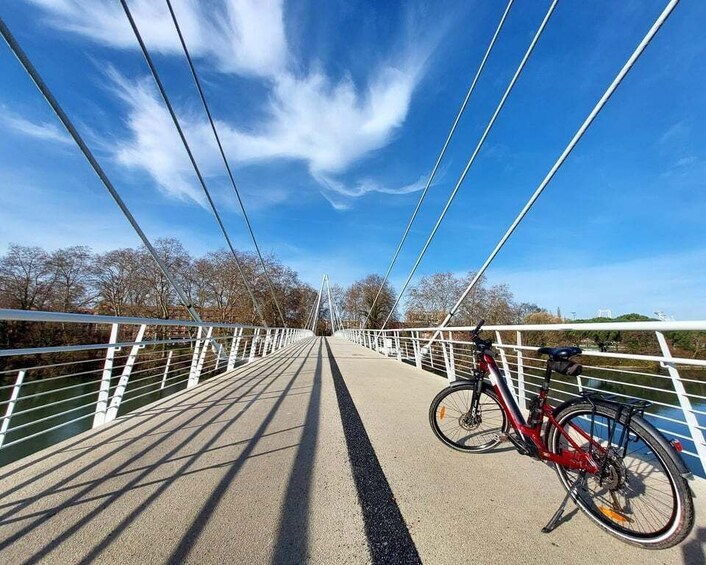 A bicycle on a bridge with white railings and a clear blue sky. 5