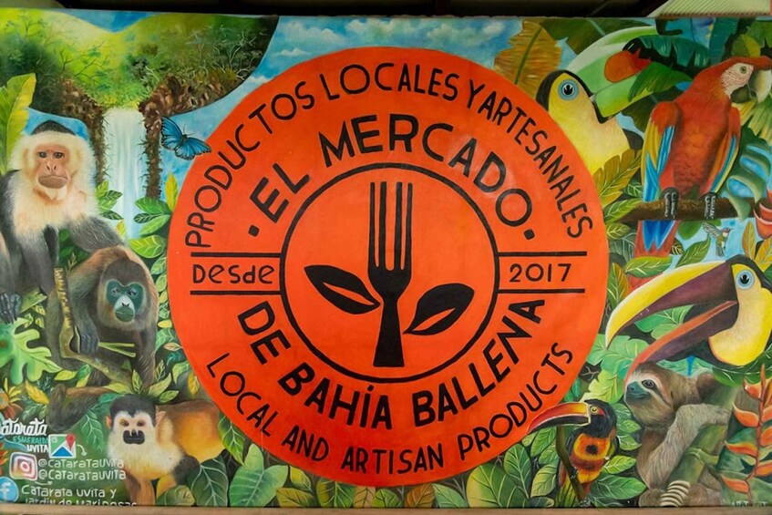 A colorful mural with a central logo for 'El Mercado de Bahía Ballena' featuring tropical wildlife. 4