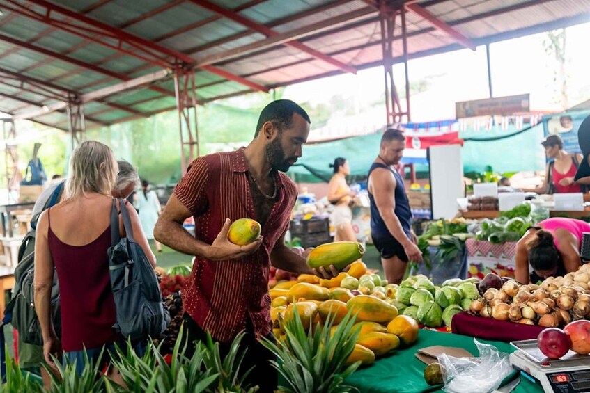 A market with various fruits and vegetables on display. 2