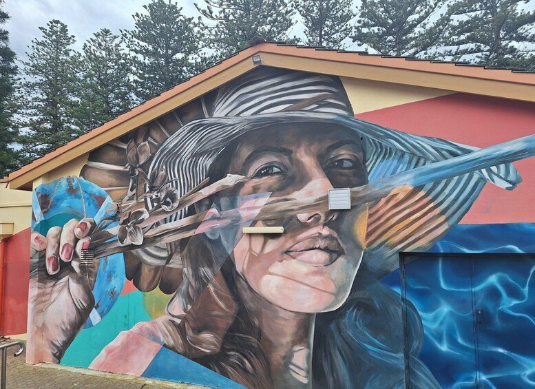 A mural with a woman's face and a blue background. 4