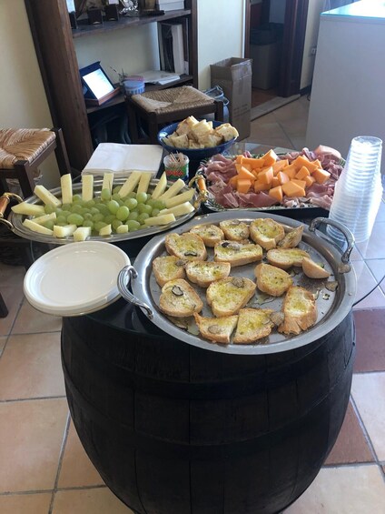 A buffet table with various food items including cheese, bread, and meats. 3