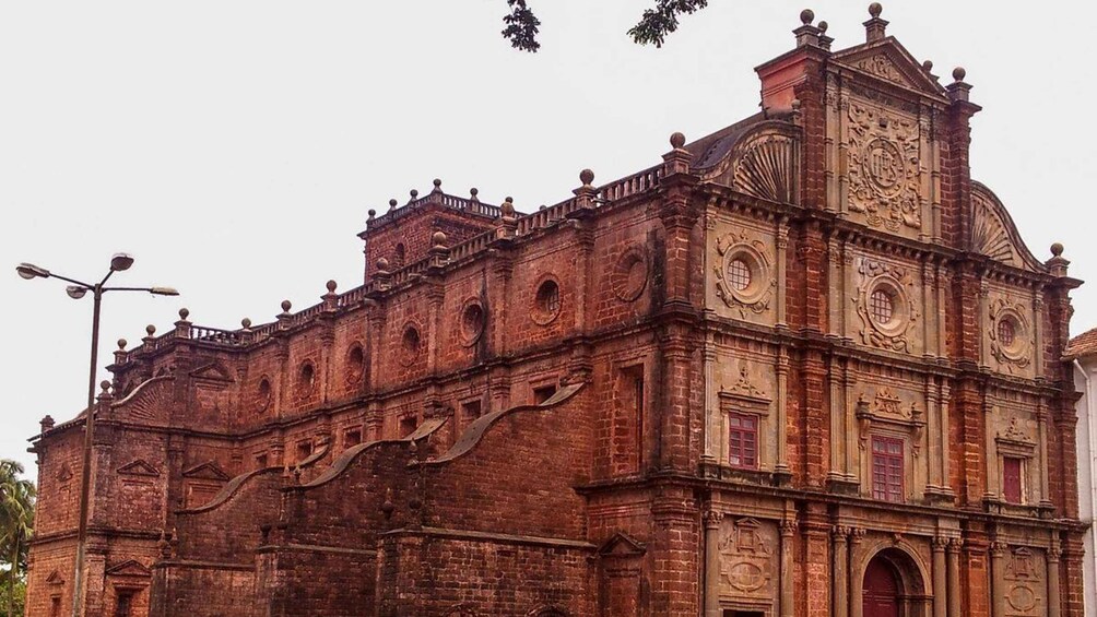 A historic brick building with ornate carvings and a prominent clock tower. 2