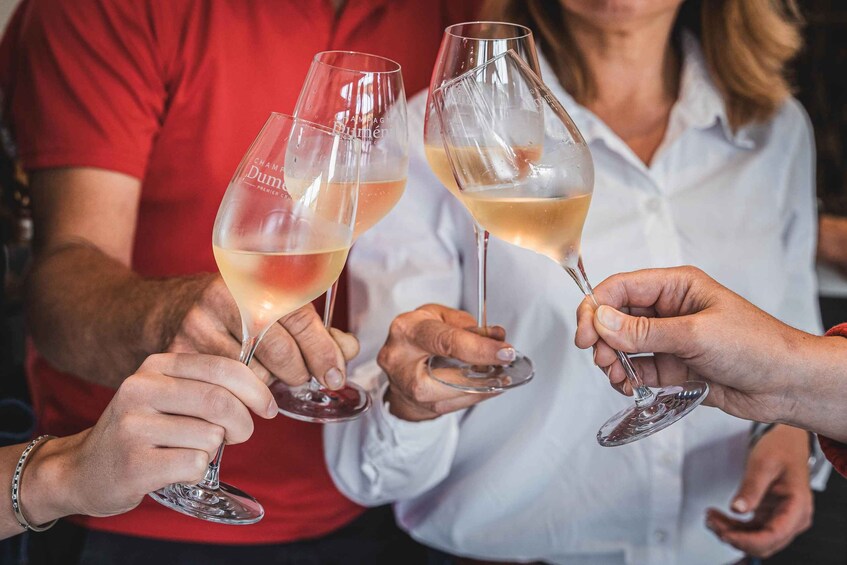 Two people holding wine glasses with a label that reads 'Champagne Dom Pérignon.' 3