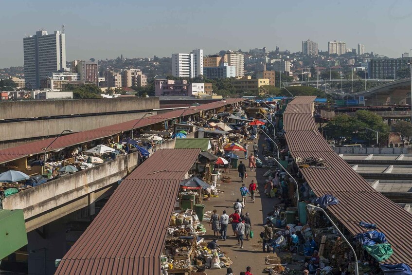 A bustling market on a bridge with vendors and shoppers. 5