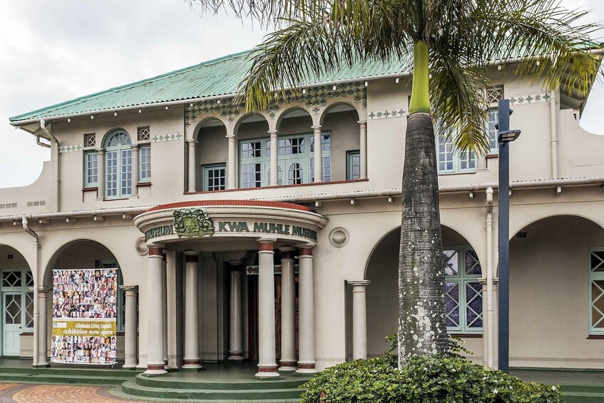 A museum with a green roof, columns, and a sign reading 'KWA MUHL MUSIUM'. 4