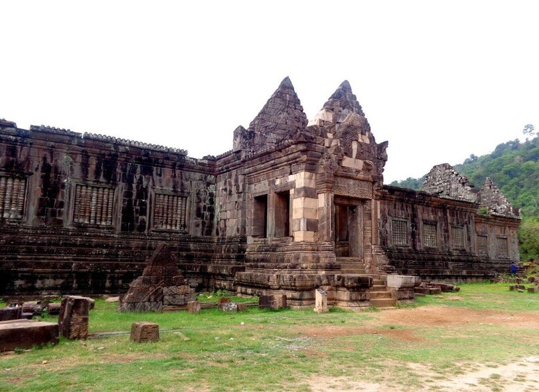 An ancient temple with intricate carvings and a central tower. 1