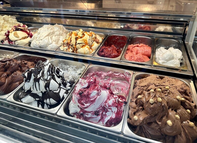 An assortment of ice cream flavors in a display case. 3
