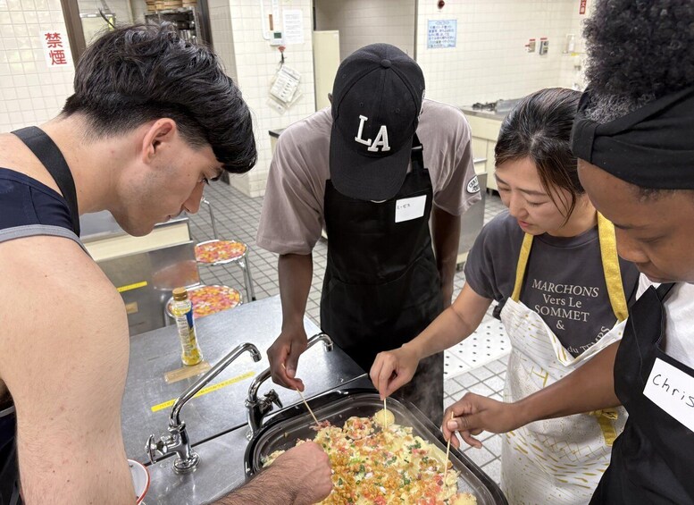 A group of people preparing food in a kitchen. 4