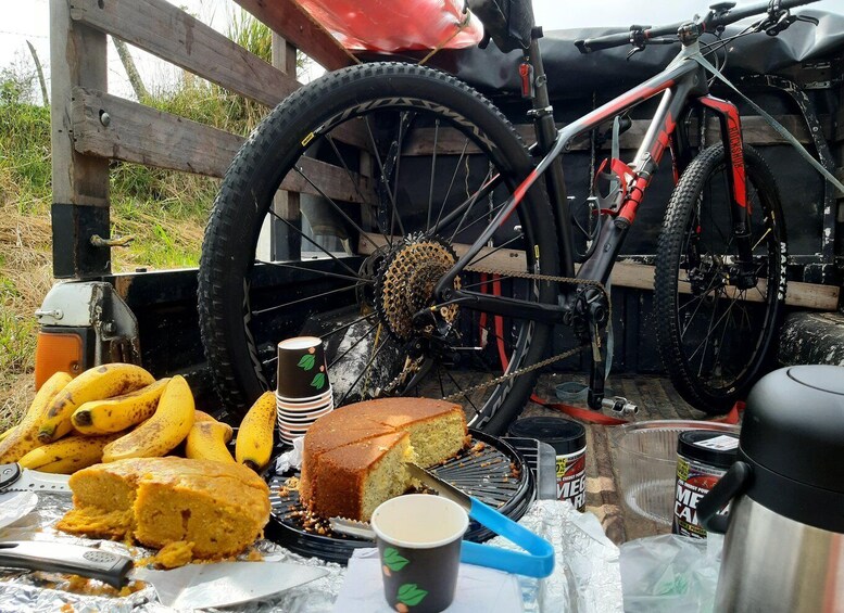 A mountain bike, bananas, a cake, and a coffee cup on a table. 3