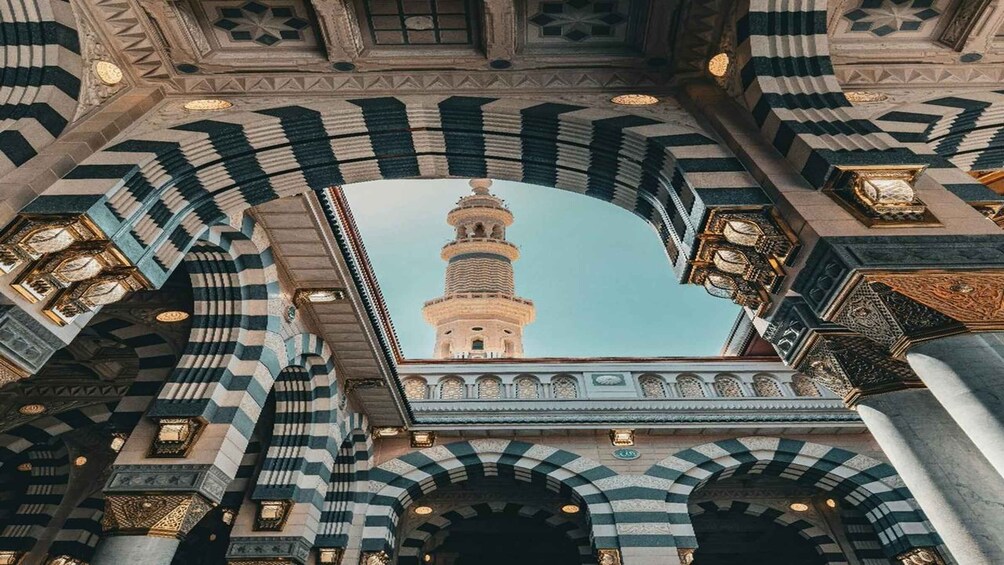 An architectural archway with a minaret in the background. 2