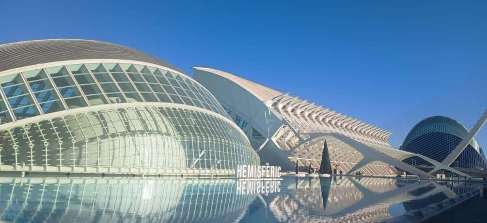 A modern architectural structure with a glass facade and a unique curved design. 4