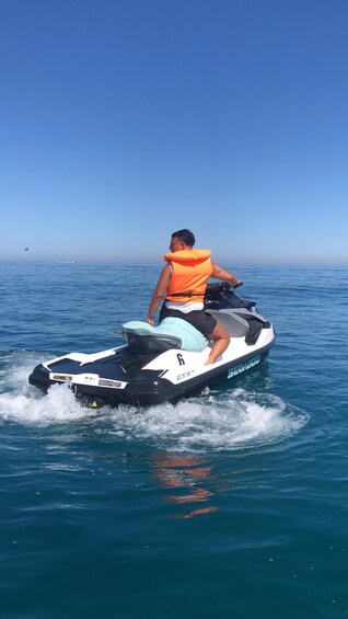 A person riding a jet ski on a body of water. 5