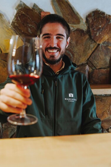 A person holding a wine glass. 4