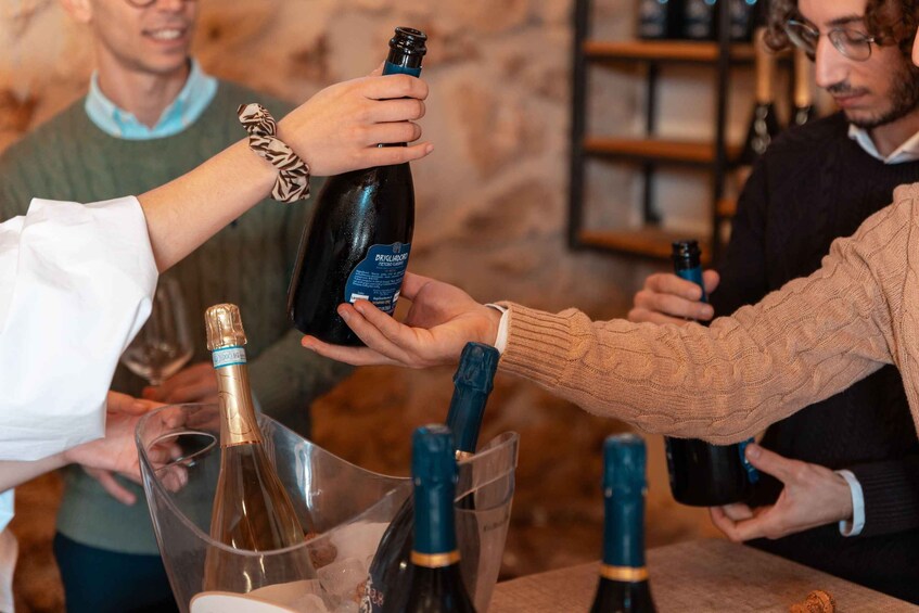 A group of people toasting with champagne bottles. 5