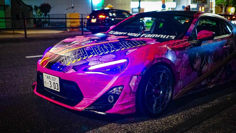 A brightly colored sports car with a license plate 't-303' parked on a street at night. 4