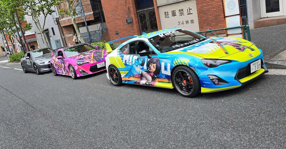 Two colorful sports cars parked on a city street. 3