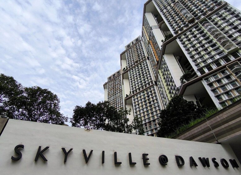 A high-rise building with the sign 'SKYVILLE @ DAWSON' in front. 3