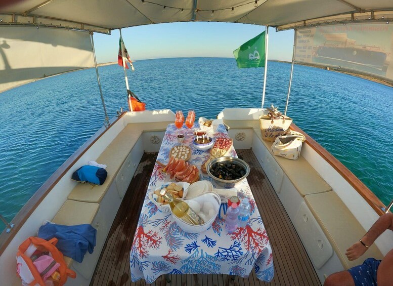 A boat with a table set for a meal, surrounded by water. 5