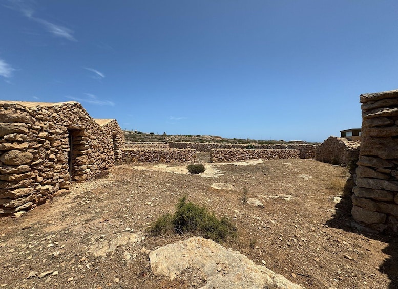 An ancient stone structure with a clear sky. 5