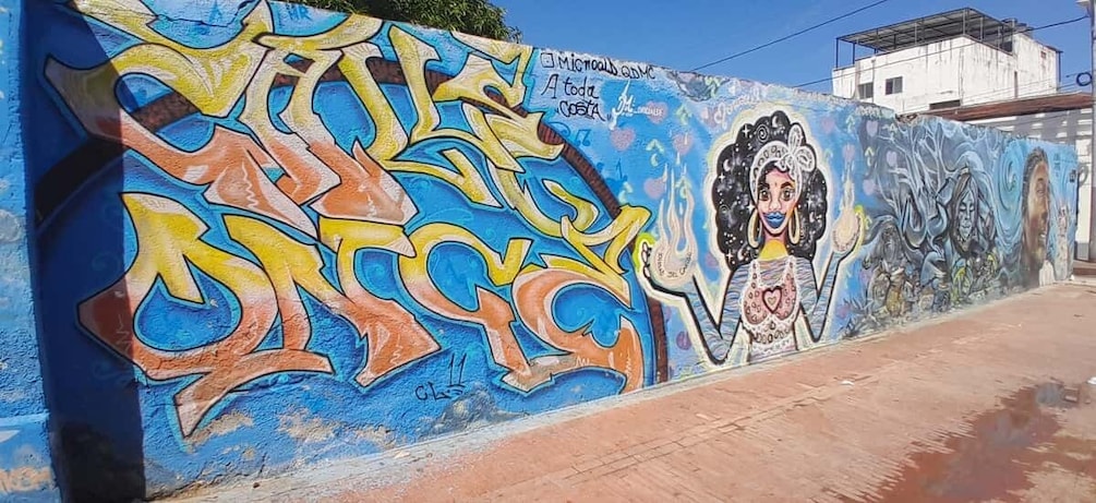 A colorful graffiti wall with abstract designs and a mural of a woman. 3