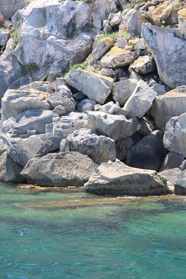 A rocky shoreline with clear turquoise water. 2