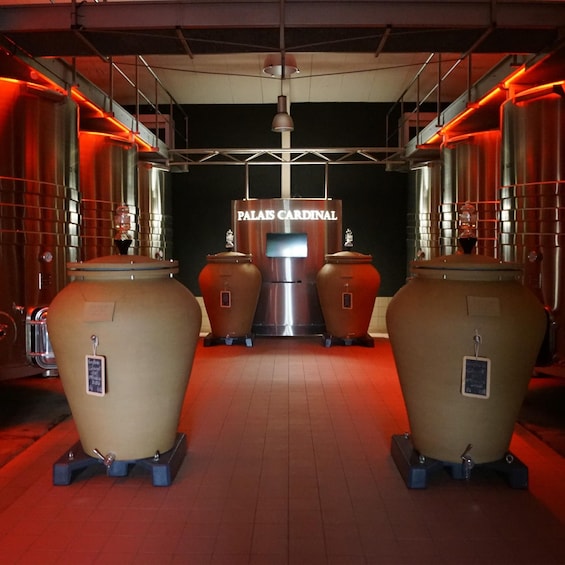 A bar with two large copper stills and a sign reading 'PALAS CARDINAL.' 4