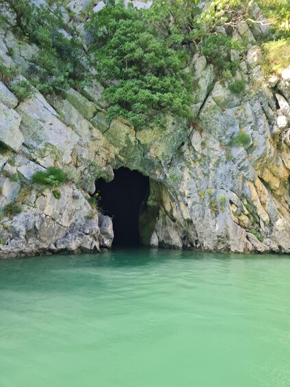 A cave entrance with water at the base. 4