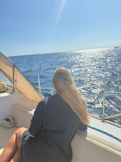 A person on a boat with a view of the ocean. 5