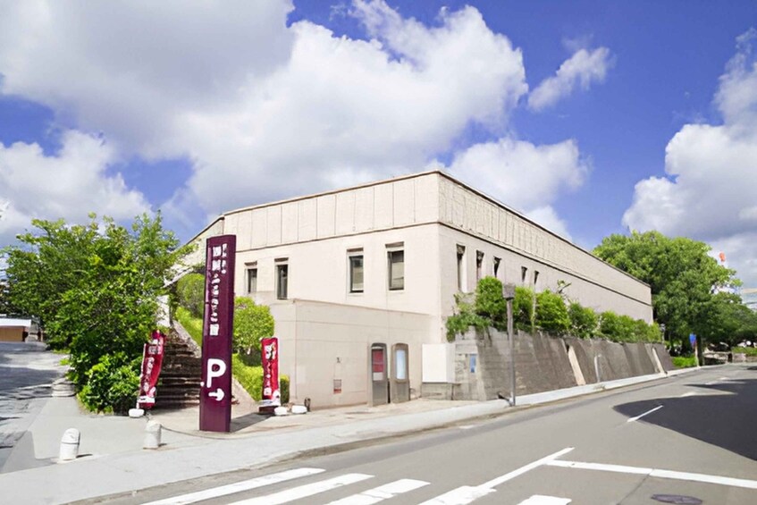 A building with a parking sign, a clear sky, and trees. 4