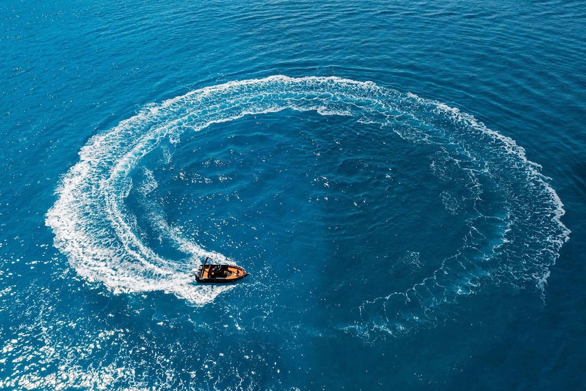 A boat creating a circular wake in the ocean. 1