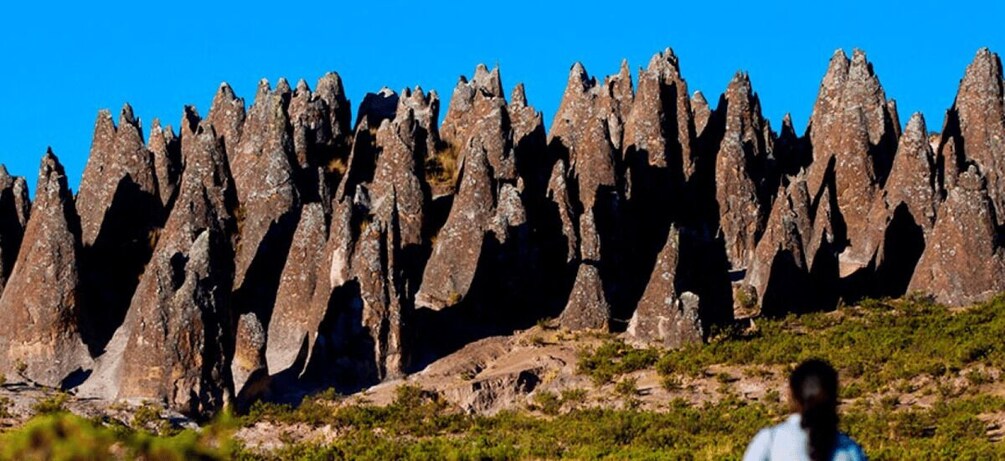 A landscape with numerous tall, pointed rock formations. 2