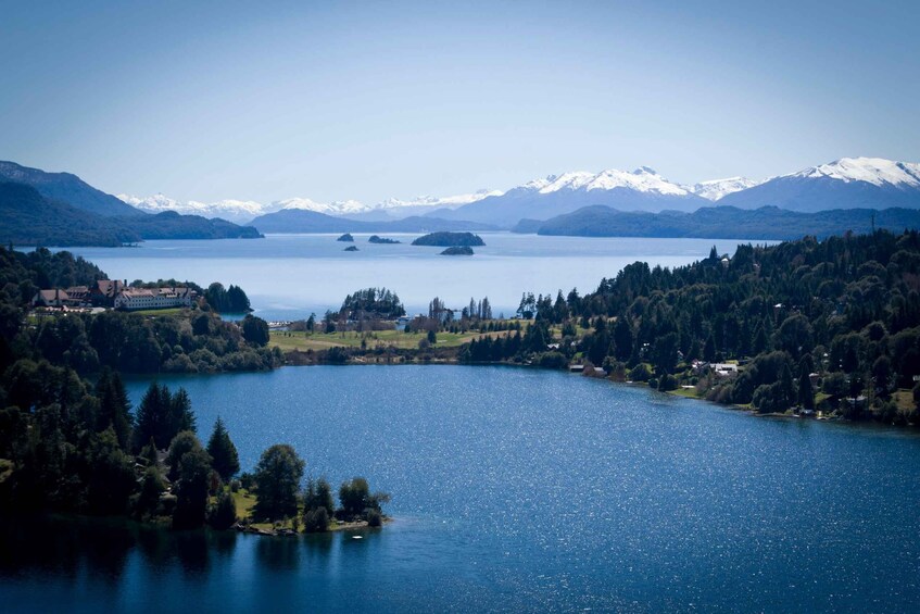 A lake surrounded by mountains and forested areas. 1