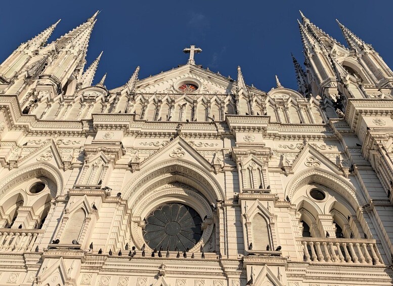 A Gothic-style cathedral with intricate spires and a large circular window. 1