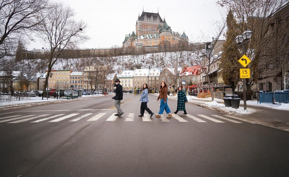 A pedestrian crossing with a historic building in the background. 1