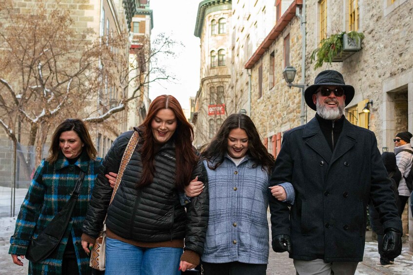 A group of people walking on a cobblestone street in an urban area with historic buildings. 3