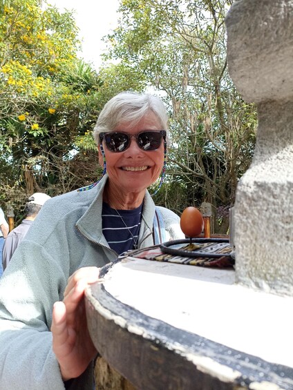 A person near a stone structure with a patterned cloth. 5